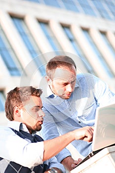 Two young college using laptop