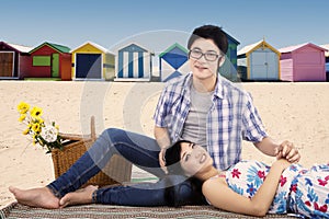 Two young couple picnic at beach