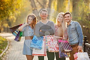 Two young couples with bags on the way to the Mall.