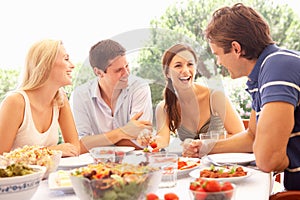 Two young couples eating outdoors photo