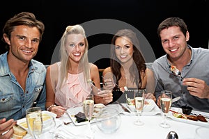 Two young couples in restaurant