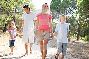 Two young couples, together, running in park