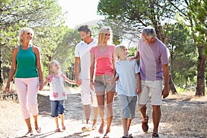 Two young couples, together, running in park