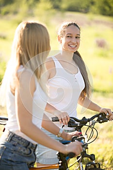 Two young cyclist girlfriends