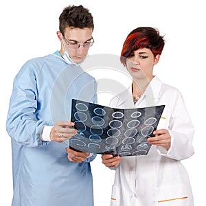 Two young doctor looking at tomography result.