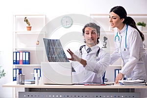 Two young doctors working in the clinic