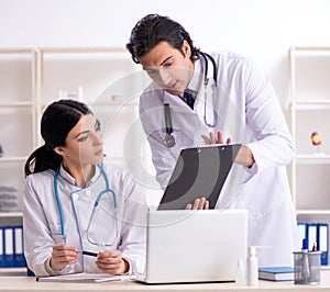Two young doctors working in the clinic