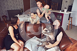 Two young European couples came to relax in country house, some have an American Bully dog, other baby girl.