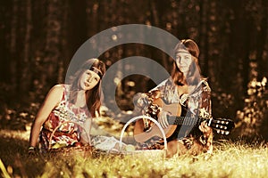 Two young fashion girls with fruit baskets in summer forest