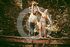 Two young fashion teen girls in a summer forest