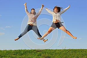 Two young fat girls jump at grass
