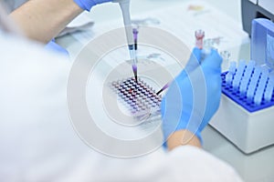 Two Young Female and male Laboratory scientists working at lab with test tubes and microscope, test or research in clinical