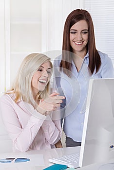 Two young female trainees during meantime looking at dating port