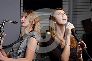 Two young females sign the song photo