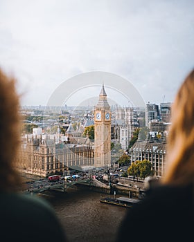 Two young females taking in the view of the iconic Big Ben clock tower in London, England