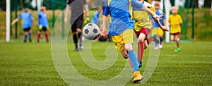 Two Young Footballers Running and Competing For Bal