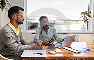 Two young freelance business people, staff meeting, analysing and advisory at modern office. Business partners, small company