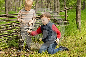 Two young friends playing in woodland