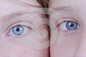 Two young girl eyes, they are looking at the camera, portrait children, macro, indoors