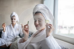 Two young girls having face beauty procedures