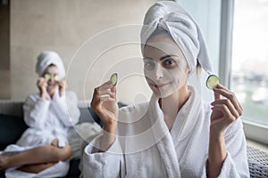 Two young girls having facial mask procedures