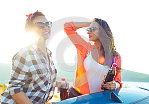 Two young girls having fun in the cabriolet outdoors