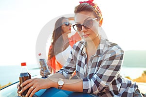 Two young girls having fun in the cabriolet outdoors