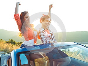 Two young girls having fun in the cabriolet outdoors