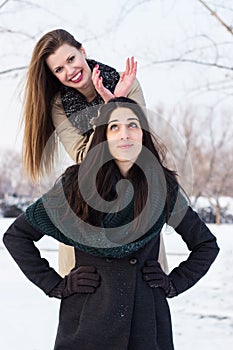 Two young girls having fun in the snow