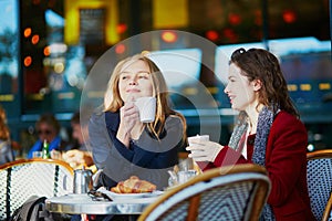 Two young girls in Parisian outdoor cafe