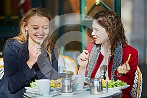 Two young girls in Parisian outdoor cafe