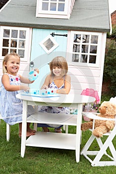 Two young girls play outdoors