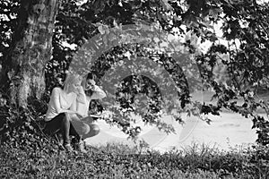 Two young girls read book