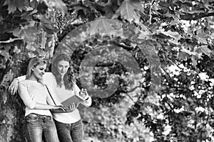 Two young girls read book