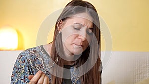 Two young girls spend time at home eating orange cake and white chocolate. Communication, friendship, laughter, evening