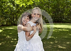 Two Young Girls in White Dresses