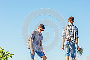 Two young guys against the sky, a relationship with each other