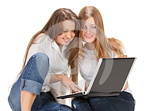 Two young happy student girl work on laptop