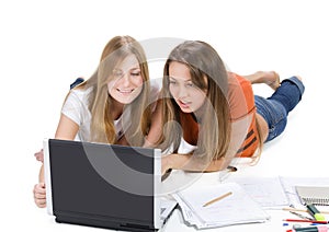 Two young happy student girl work on laptop