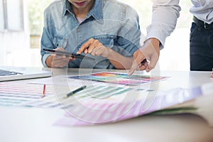 Two young interior design or graphic designer working on project