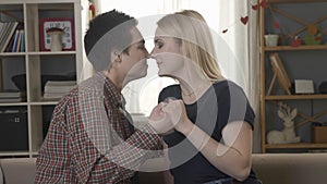 Two young lesbians cute look at each other, wrestle with hands, nose to nose, touching noses, smiling, laughing, lgbt 60