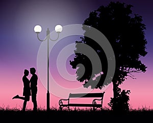 Two young lovers embracing under a tree and a shining lamp with