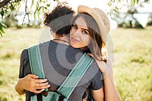 Two young lovers hugging in the forest