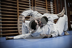 Two young males practicing judo.