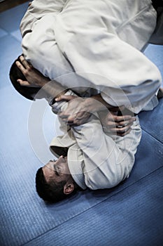 Two young males practicing judo