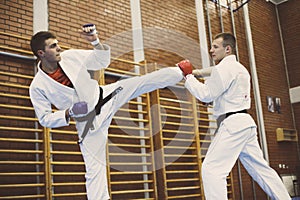 Two young males practicing judo together.