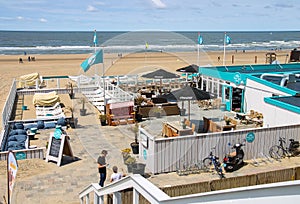 Two young man in beach cafe terrace near the North sea