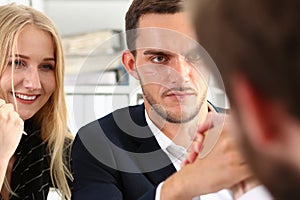 Two young man holding each other hands over desk in the office