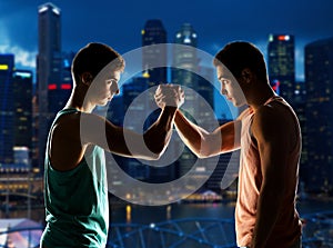 Two young men arm wrestling