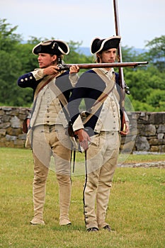 Two young men dressed as soldiers reenacting musket demonstration,Fort Ticonderoga,New York,2014